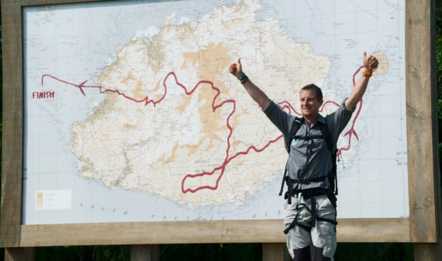 Bear Grylls exclaiming in front of an East View Geospatial produced custom topographic map of Fiji